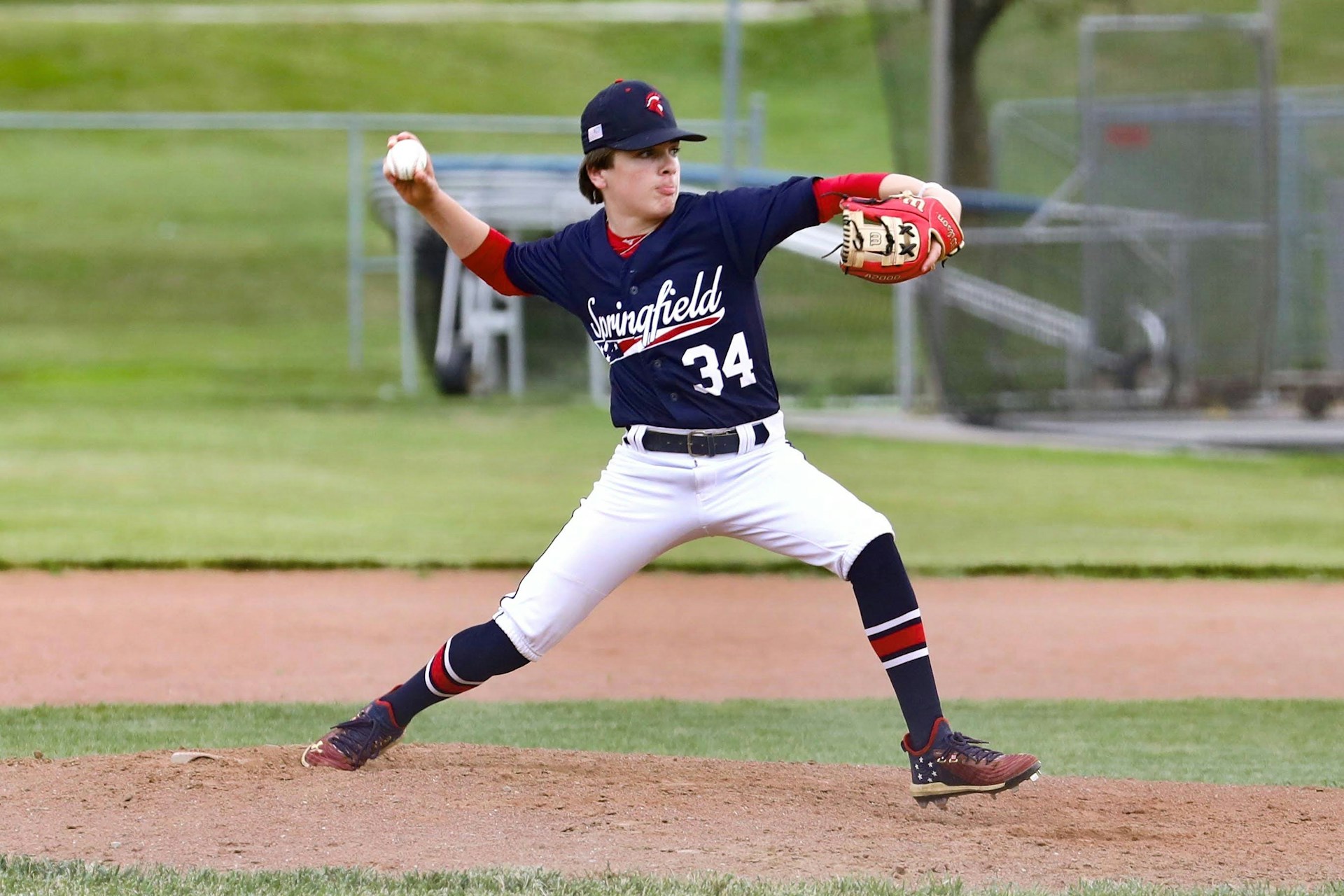 Young baseball players practicing throwing and fielding drills on an outdoor baseball field to improve their skills
